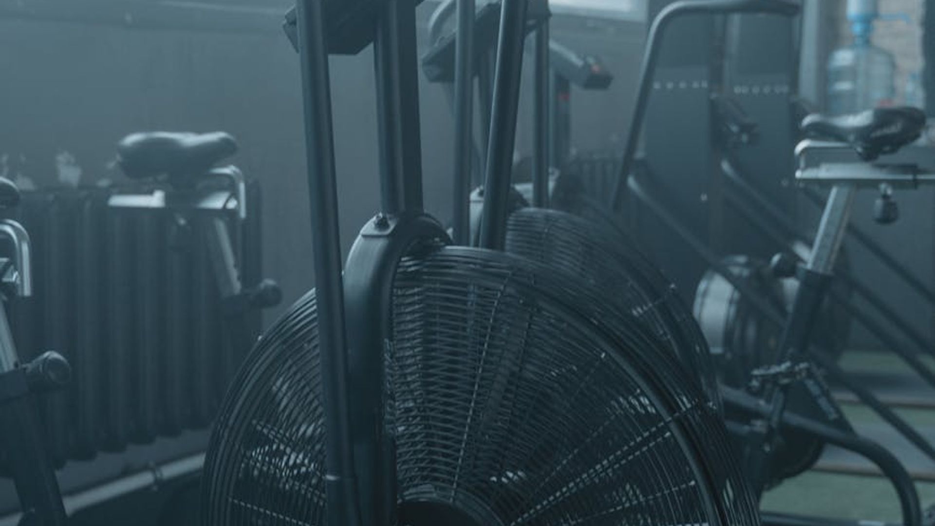 Atmospheric gym interior with soft lighting and cardio equipment