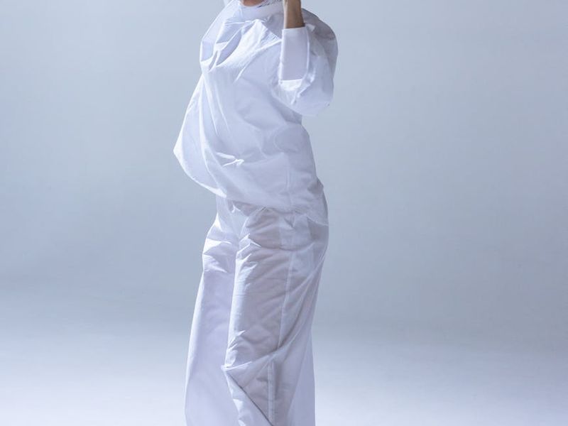 Person focused on movement in a minimalist studio setting